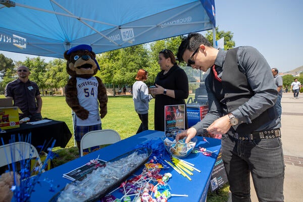 Simon Tam stops by the CHASS booth on Tuesday, April 25, 2023. (UCR/Stan Lim)