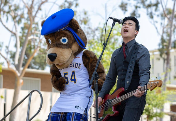 The Slants' Simon Tam with Scotty during the inaugural CHASS Dean's Speaker Series on Tuesday, April 25, 2023 at UC Riverside. (UCR/Stan Lim)