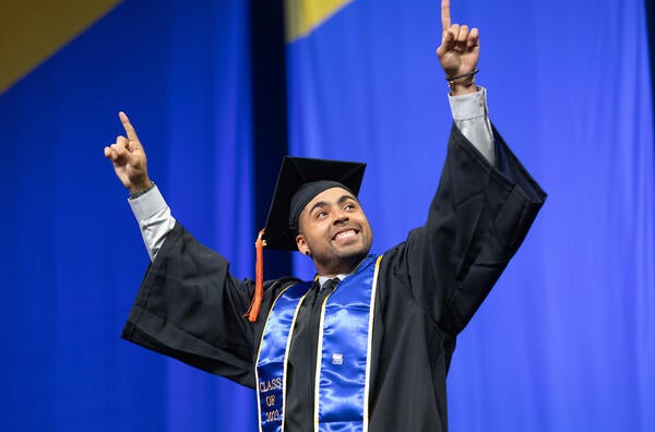 Graduate celebrating on stage