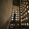 Man walking up inside of belltower stairs