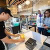 Student worker serving boba to customers.