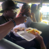 Student eats meal in van