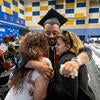 Graduate hugging family/friends