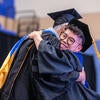 Graduate hugging faculty/staff