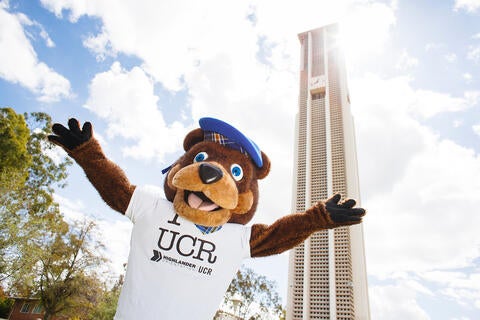Scotty the bear mascot in front of Bell Tower