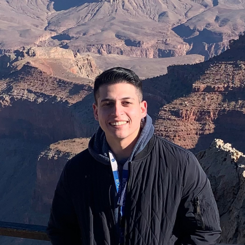 Person standing in front of Grand Canyon