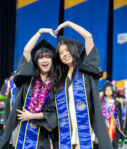 Graduates making heart with hands