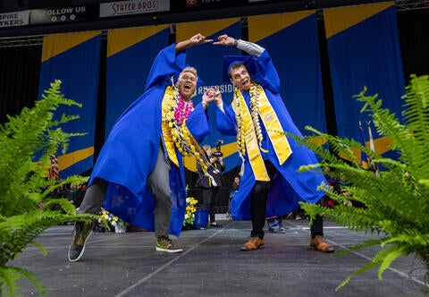 Graduates making heart with hands
