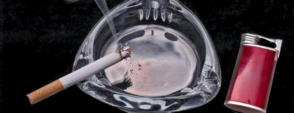 A cigarette smoking in an ashtray