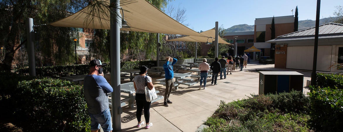 Employees line up at the COVID-19 vaccination clinic at the School of Medicine Education Building at UC Riverside on March 19, 2021.  (UCR/Stan Lim)