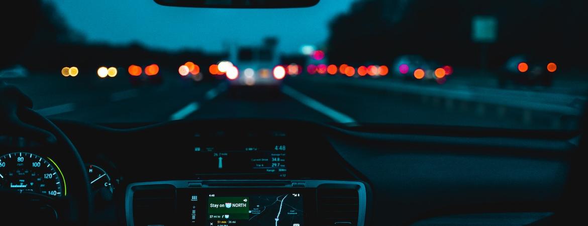 A car driving in low light.