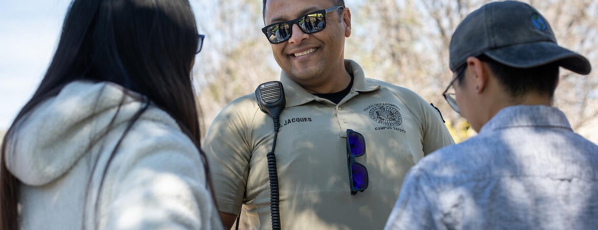 Campus safety responder Oscar Jacques with two students