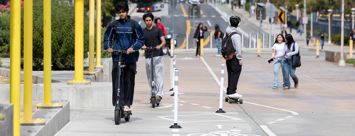 Students on scooters in bike lane