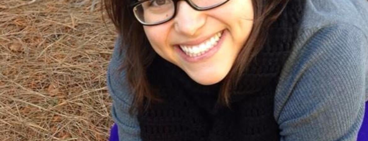 Mycologist Sydney Glassman holding a mushroom