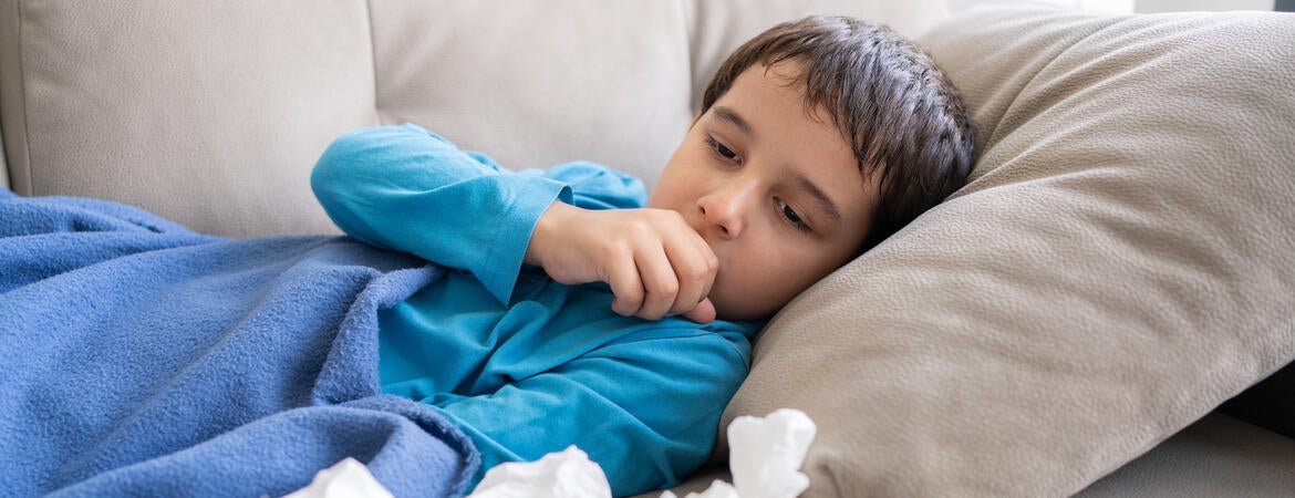 Child coughing in bed