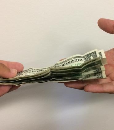 One person puts money into another person's hand