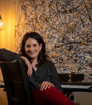 Dana E. Kaufman, assistant professor for UC Riverside’s Department of Music, in her home on March 30, 2021, in Riverside. (UCR/Stan Lim)
