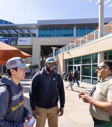 Campus safety responder Oscar Jacques with two students