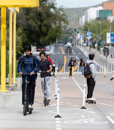 Students on scooters in bike lane