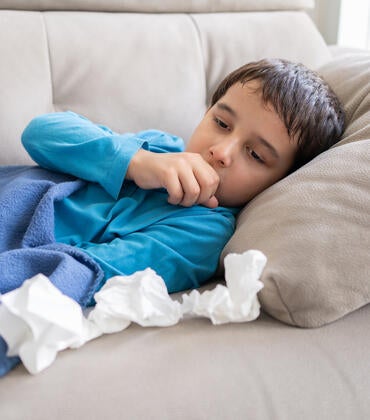 Child coughing in bed