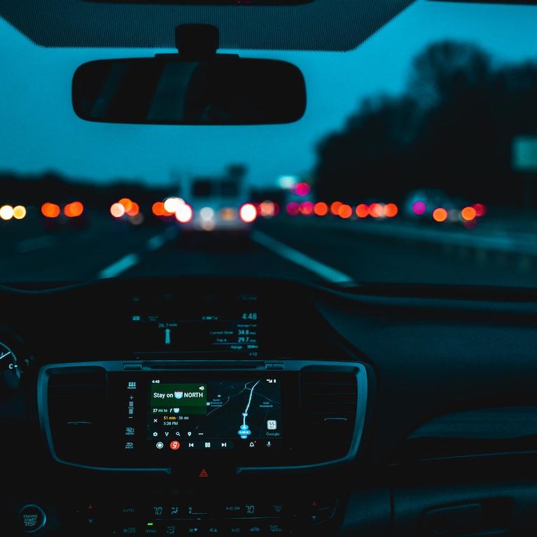A car driving in low light.