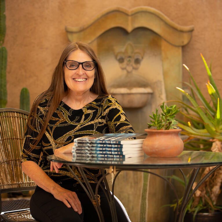Allison Adelle Hedge Coke, a distinguished professor of creative writing at UC Riverside, with her newest book, “Look at This Blue.” The book published March 29, 2022. (UCR/Stan Lim)