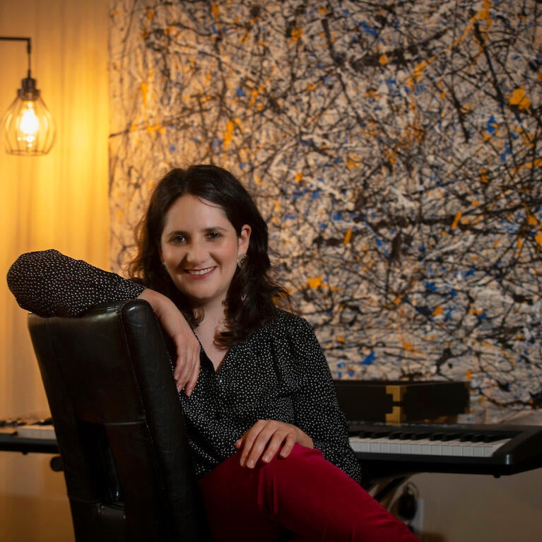 Dana E. Kaufman, assistant professor for UC Riverside’s Department of Music, in her home on March 30, 2021, in Riverside. (UCR/Stan Lim)
