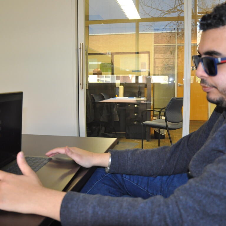 Student Kald Alhomse with laptop