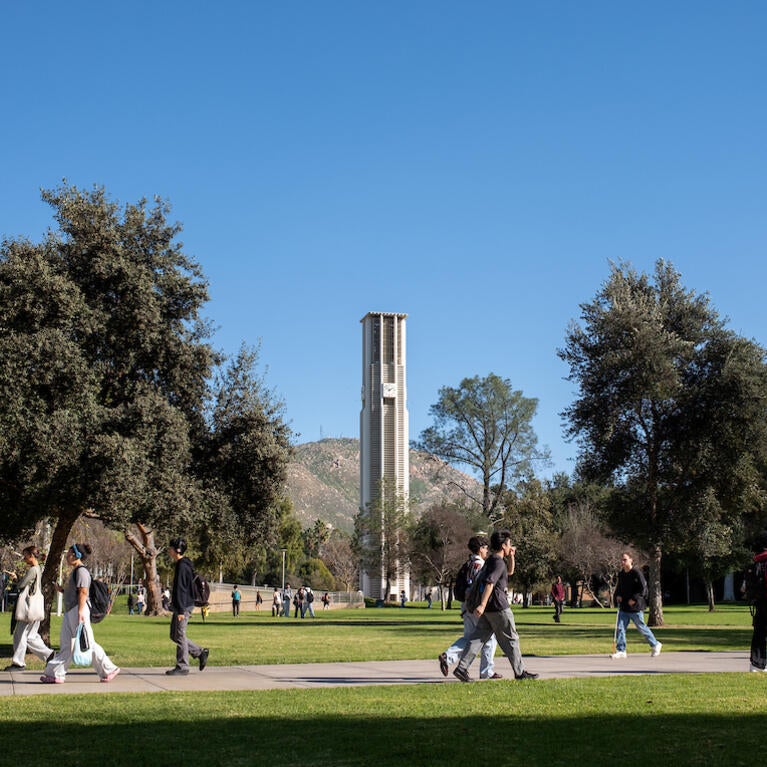 Campus bell tower and lawn with students