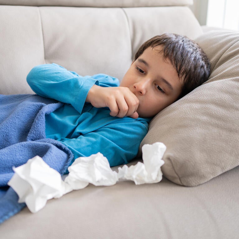 Child coughing in bed