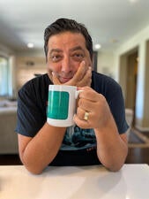 Author Tod Goldberg holds a mug.