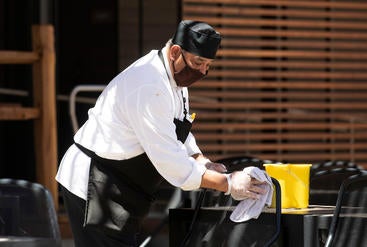 The Barn cook wipes down table