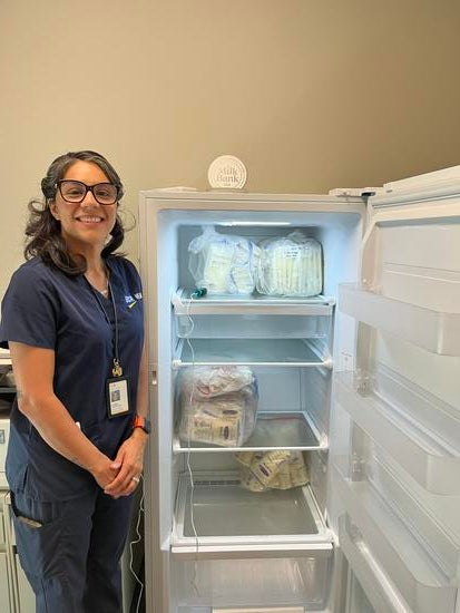 Rubie Onate stands next to freezer