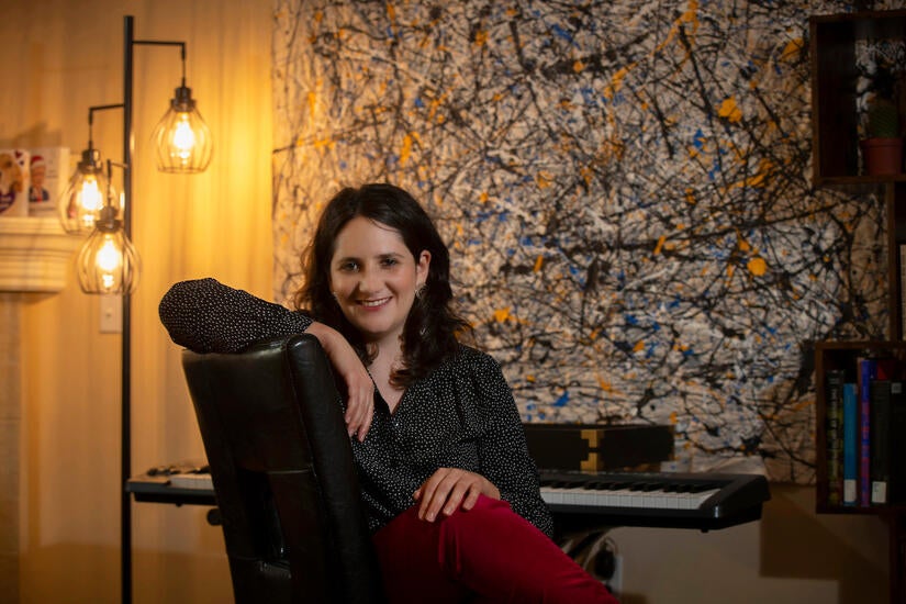 Dana E. Kaufman, assistant professor for UC Riverside’s Department of Music, in her home on March 30, 2021, in Riverside. (UCR/Stan Lim)