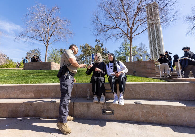 Campus safety responder Oscar Jacques with two students