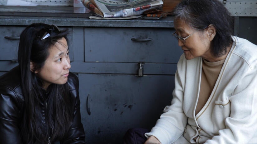 Carol K. Park and her mom, Son Park, at the family gas station garage in 2012. (Photo courtesy of Carol K. Park)