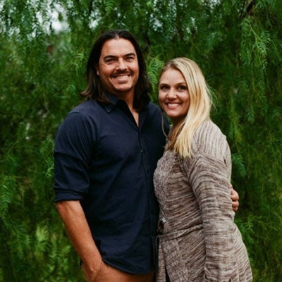 Andy ’94 & Keri ’94 Alumni couple Andy ’94 & Keri ’94 stand in front of greenery