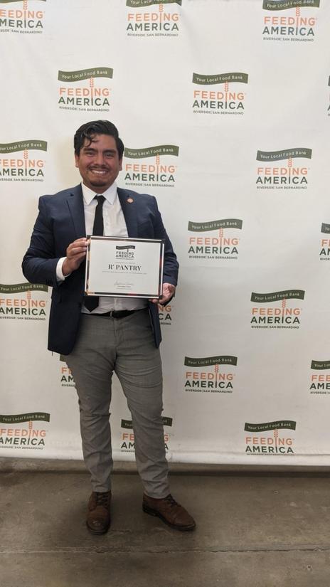 Daniel Lopez Salas, R’Pantry coordinator, holds the 2020 Charity of the Year award. (Photo courtesy of Daniel Lopez Salas)